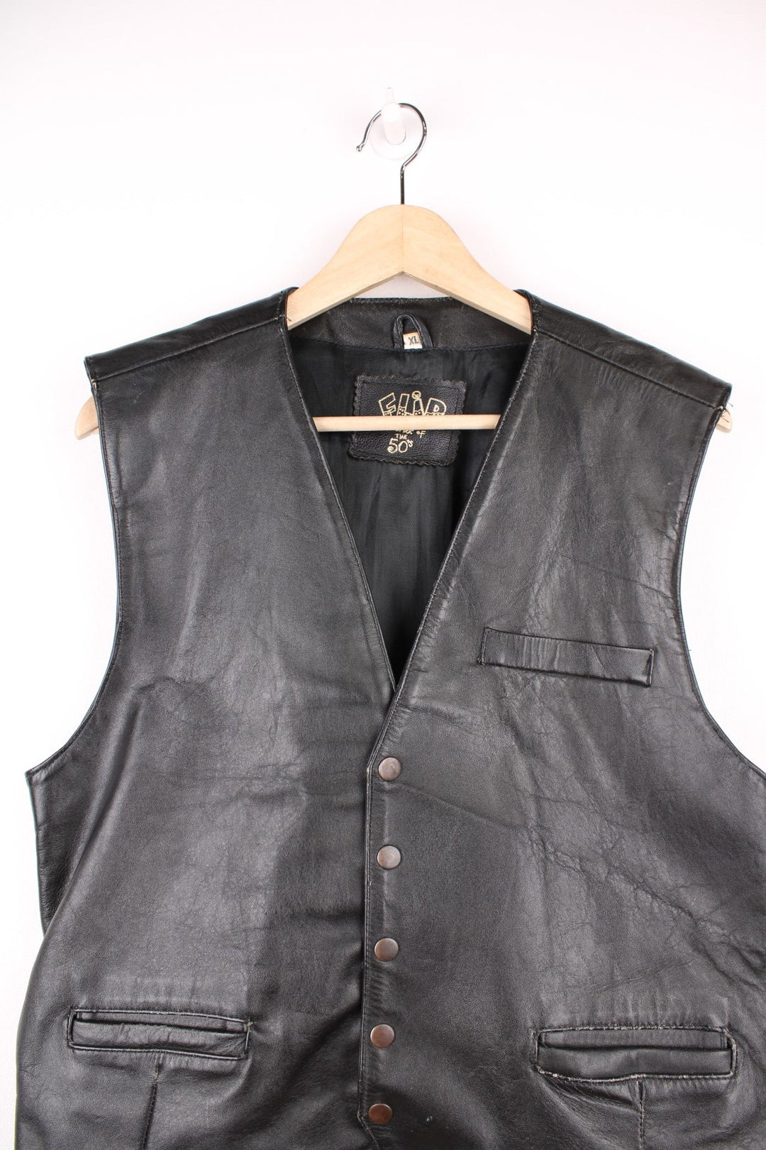 Flip 'The Spirit of the 50s' black leather vest with three pockets and snap closure.