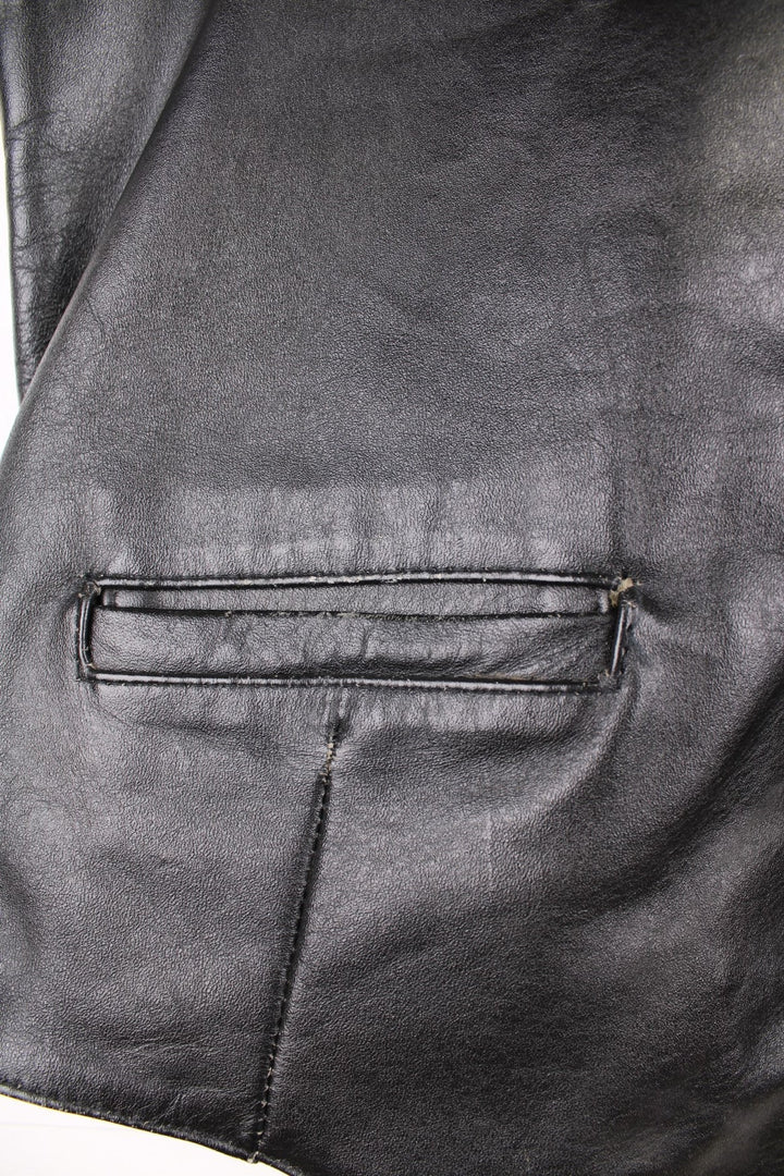 Flip 'The Spirit of the 50s' black leather vest with three pockets and snap closure.