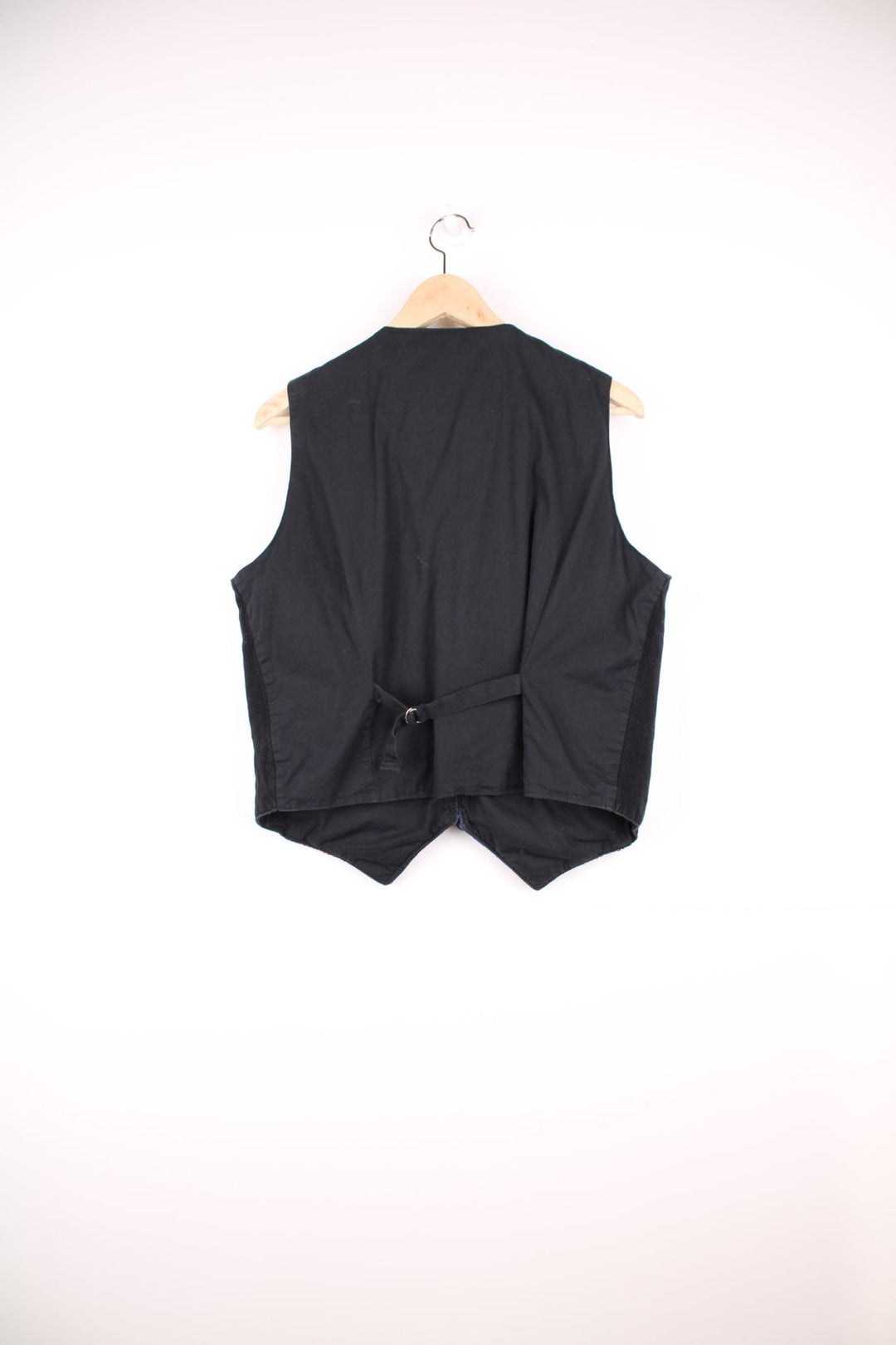 Vintage black vest with multicoloured embroidery, button closure, and a buckled waist adjuster on the back. Handmade in Guatemala.