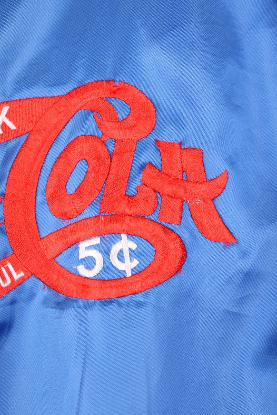 Blue 'Pepsi-Cola' personalised bomber jacket with white striped accents around the collar and cuffs. Snap closure, with the Pepsi-Cola logo embroidered on the chest and back.