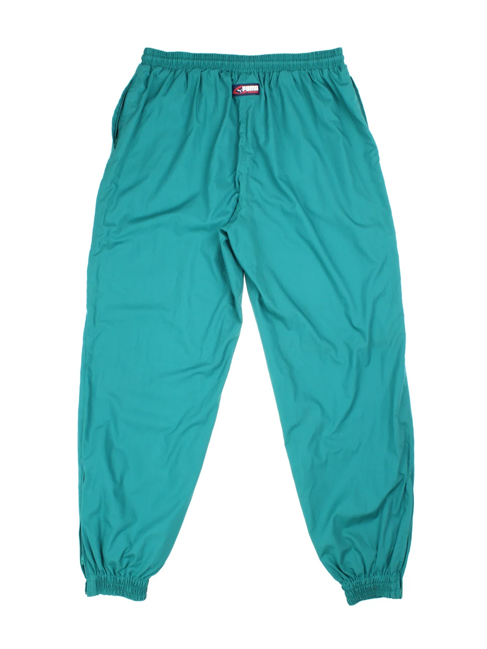 Puma Tracksuit Bottoms in green colourway with cuffed legs and two standard side pockets. Zip up leg with small classic logo on the front.