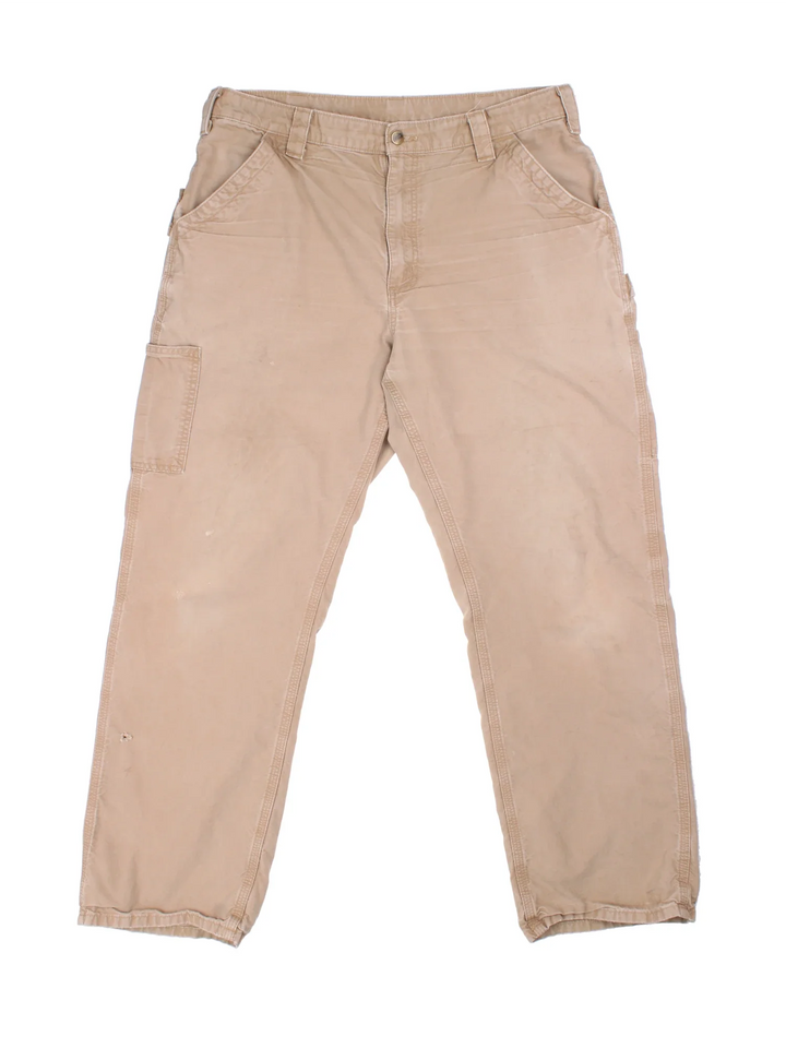 Carhartt Trousers in tan colourway with multiple pockets and the logo embroidered on the back.