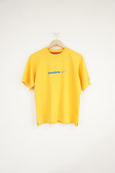 Vintage yellow waffled Reebok tee featuring embroidered logo on the front