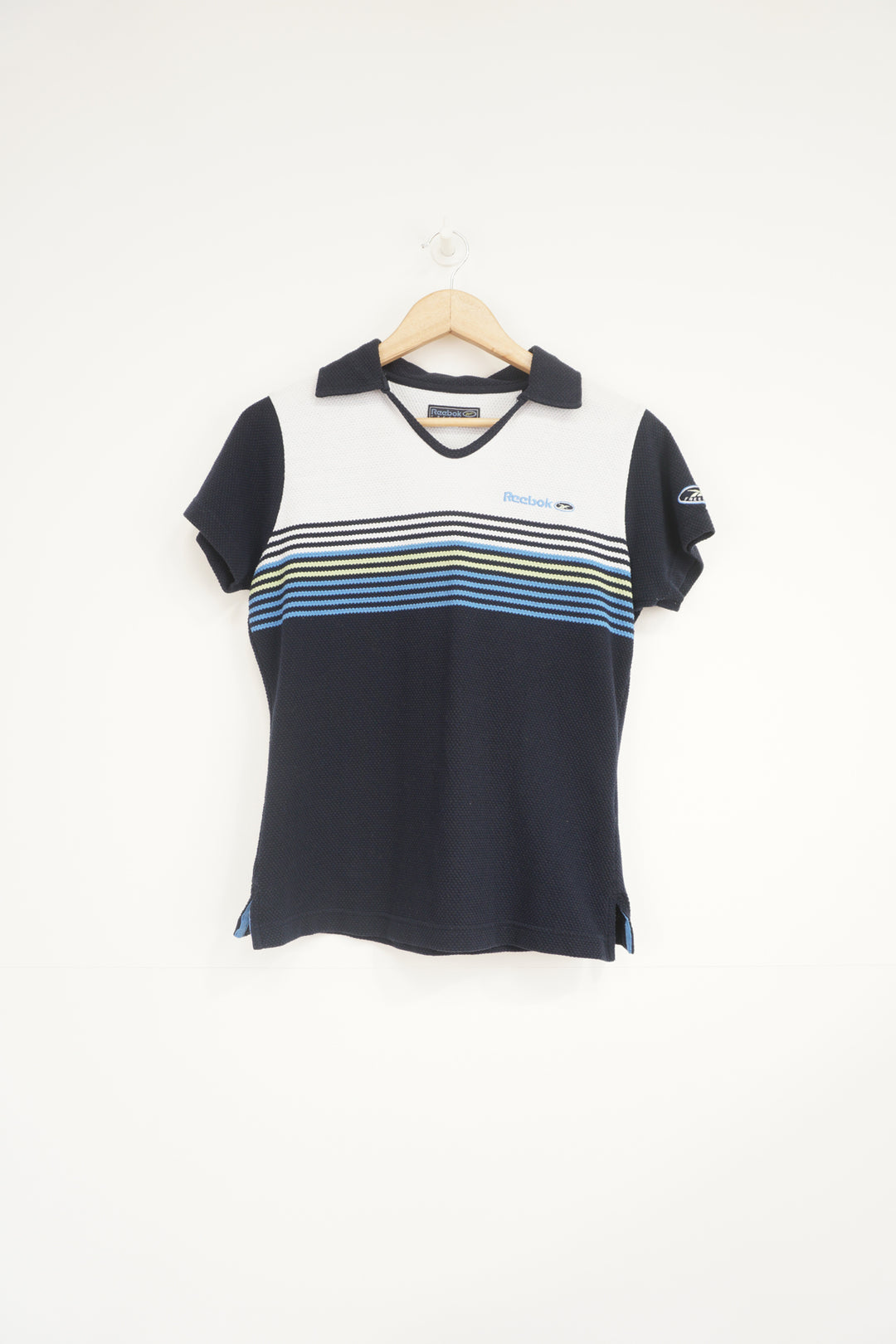 Navy blue Reebok Freestyle polo shirt with embroidered logo on the chest