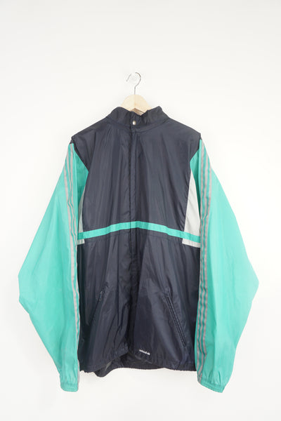 Vintage 90's green and blue  Adidas full zip up windbreaker jacket with foldaway hood and embroidered logo on the hem