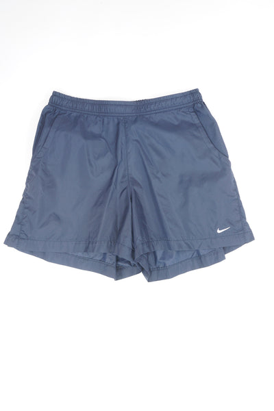 Nike navy blue nylon sports shorts with white embroidered swoosh on the leg 