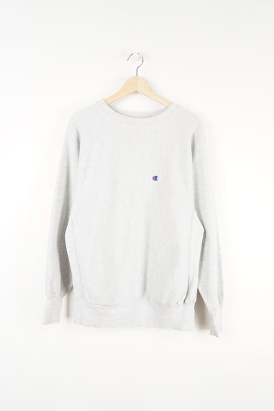 Champion light grey reverse weave sweatshirt features embroidered logo on chest