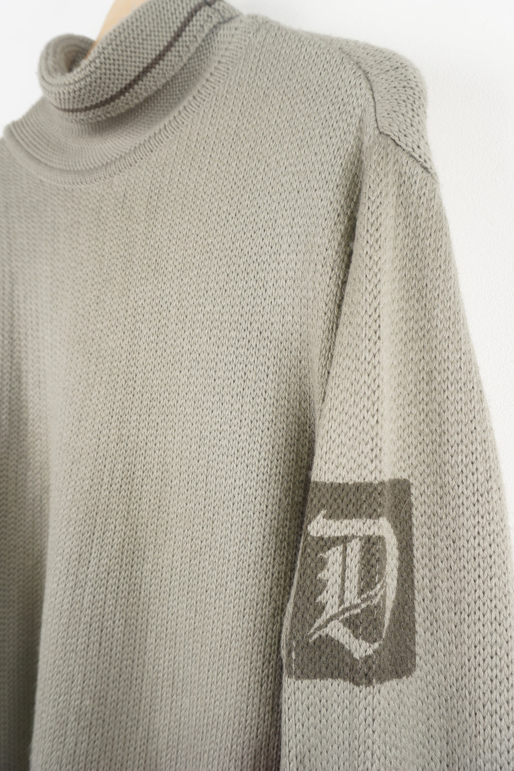 Diesel khaki green roll neck knitted jumper features signature logo on the shoulder