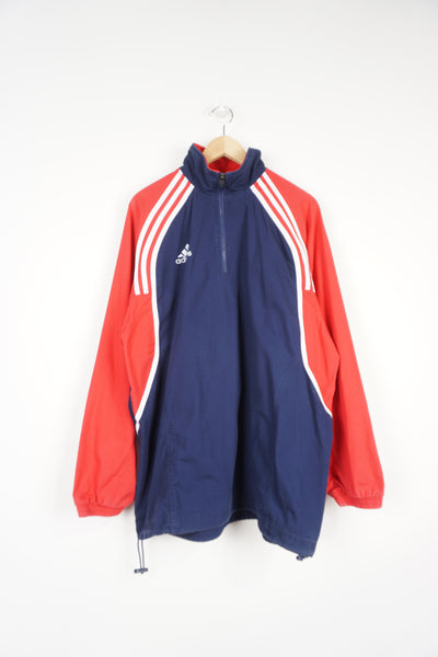 Adidas blue and red, 1/4 zip cotton tracksuit top. With embroidered logo on the chest and three stripe details down both sleeves 