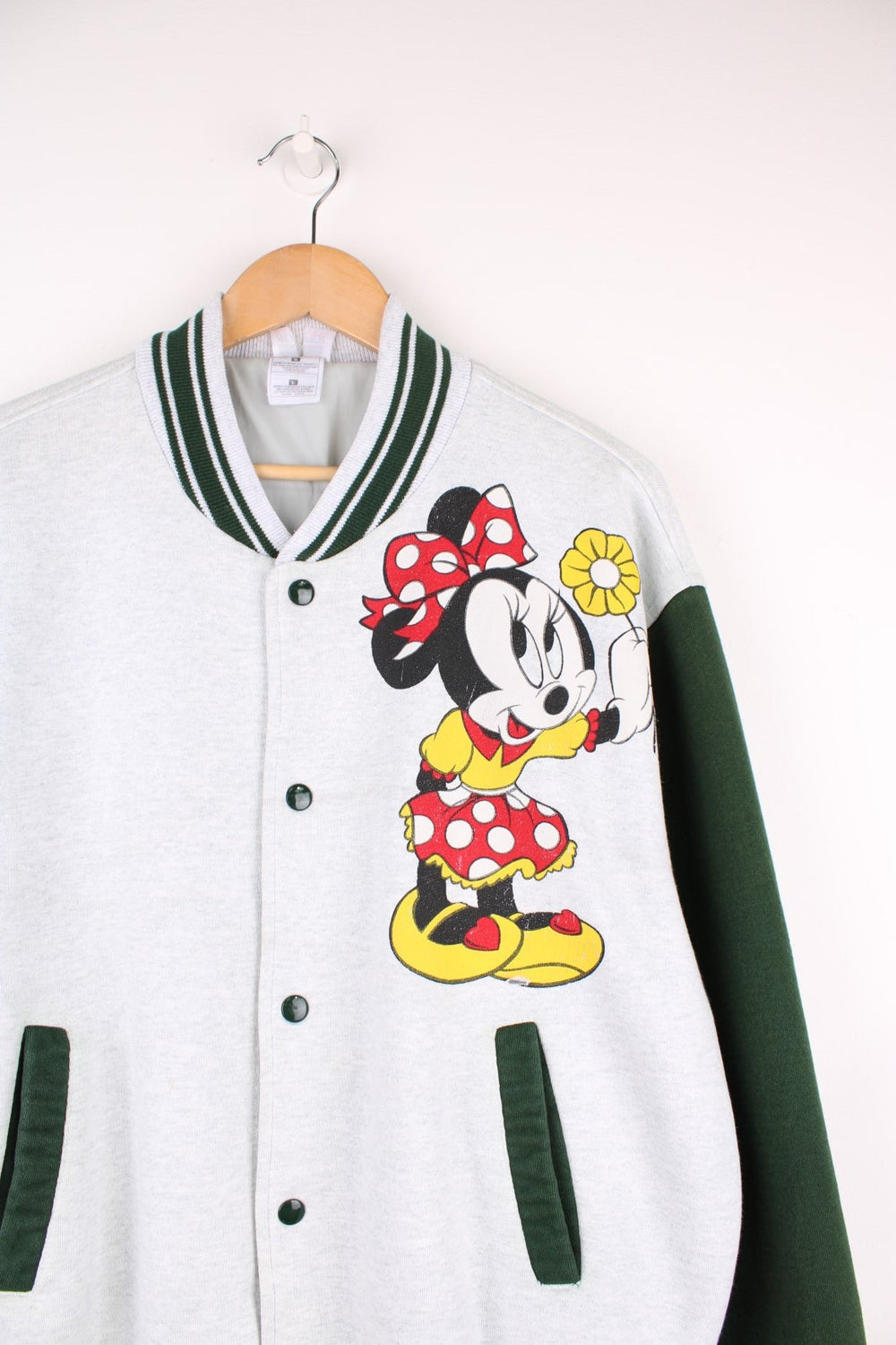 Vintage Disney Minnie Mouse Cotton Varsity Jacket in a grey and green colourway, button up with side pockets, has a nylon lining, and Minnie Mouse printed on the front.