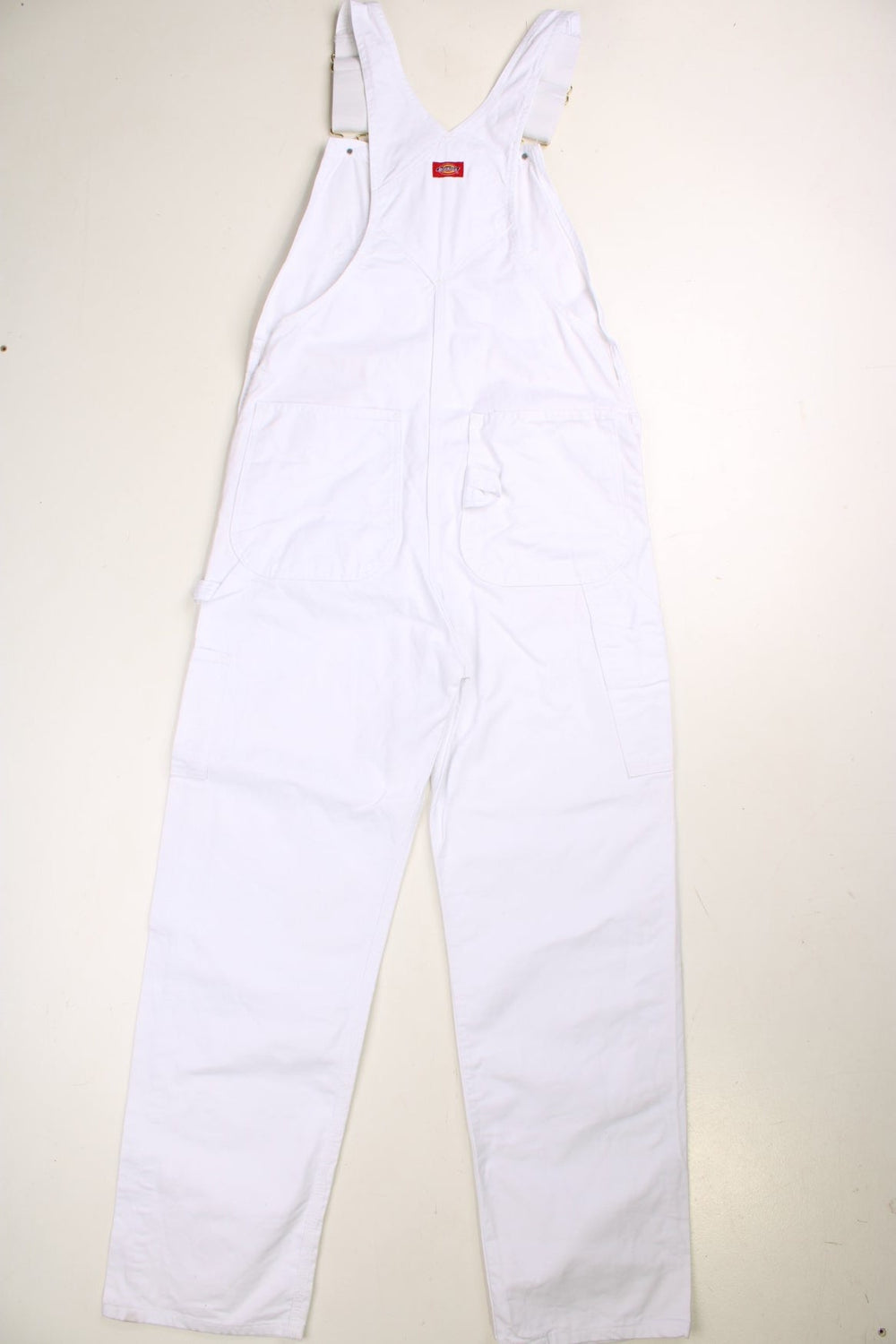 Dickies dungarees in white with multiple pockets and a red logo patch.