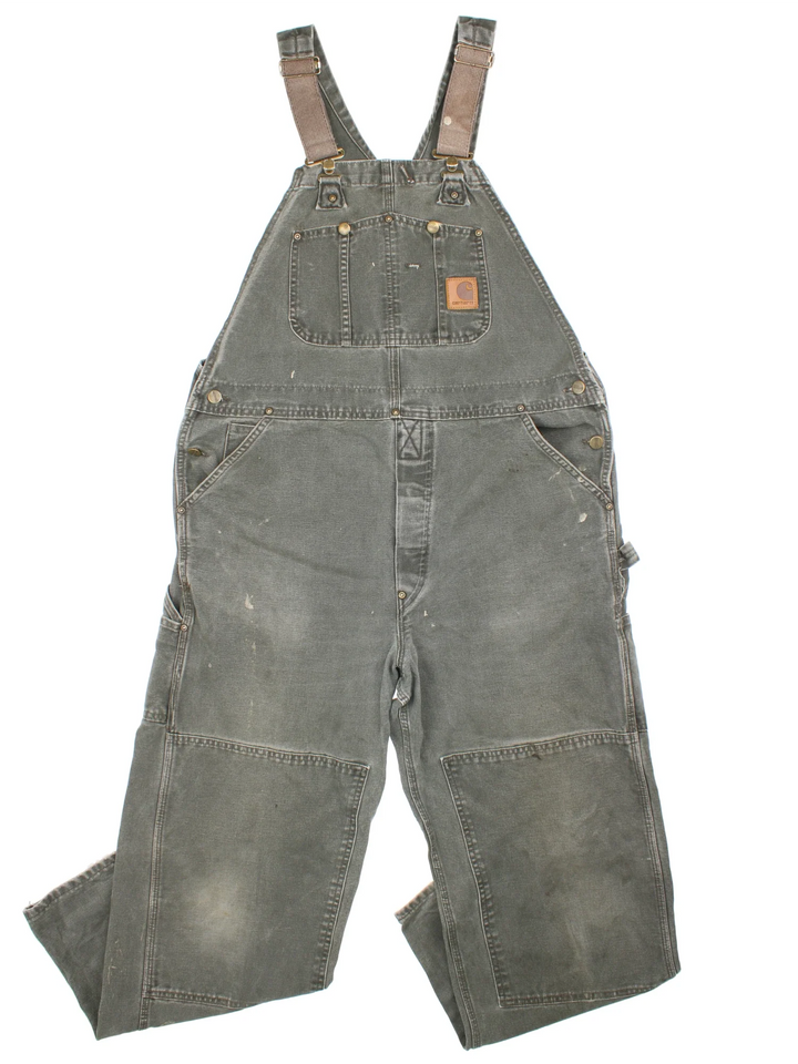 Carhartt Dungarees in green colourway with multiple pockets, adjustable straps and the logo embroidered on the front.
