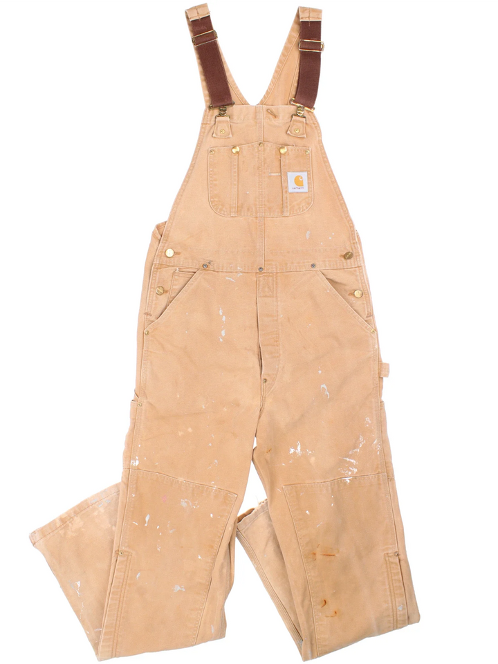 Carhartt Dungarees in tan colourway with multiple pockets, adjustable straps and the logo embroidered on the front.