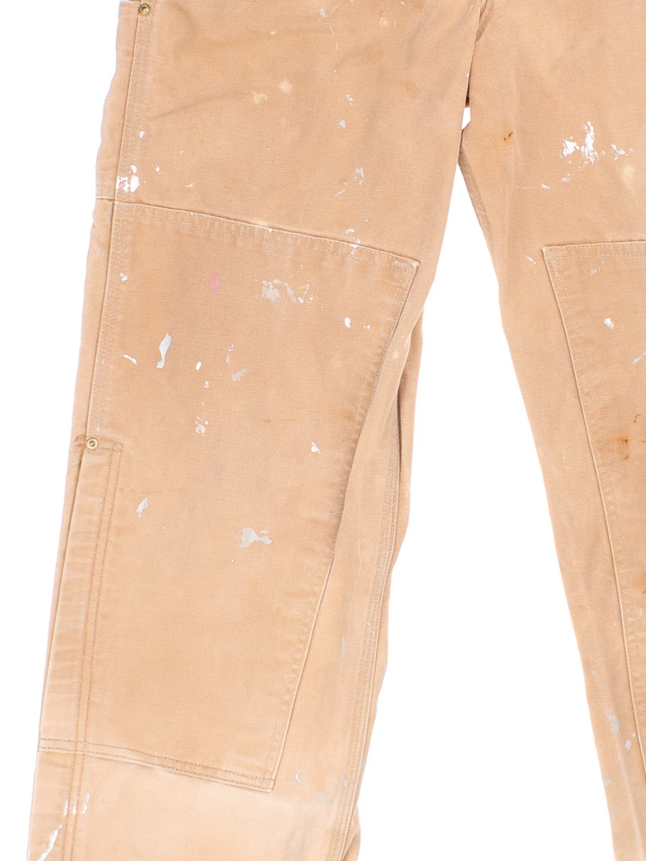 Carhartt Dungarees in tan colourway with multiple pockets, adjustable straps and the logo embroidered on the front.