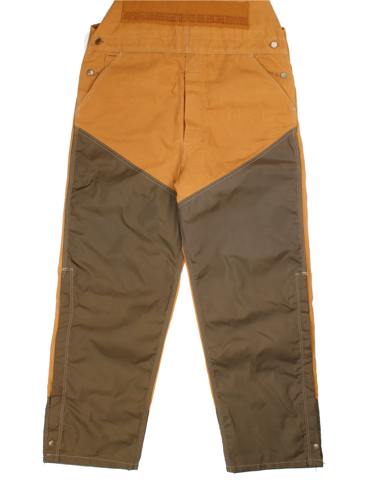 Carhartt Dungarees in tan colourway with multiple pockets, adjustable straps and the logo embroidered on the front.