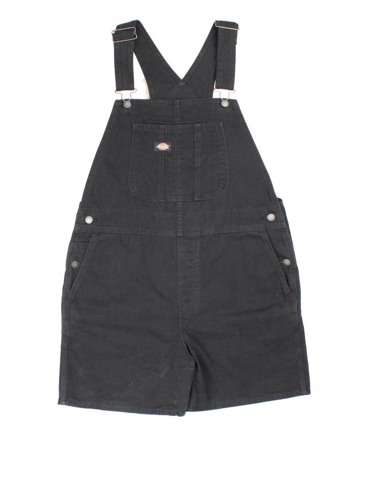 Dickies Short Dungarees in black colourway with multiple pockets, adjustable straps and the logo embroidered on the front/back.