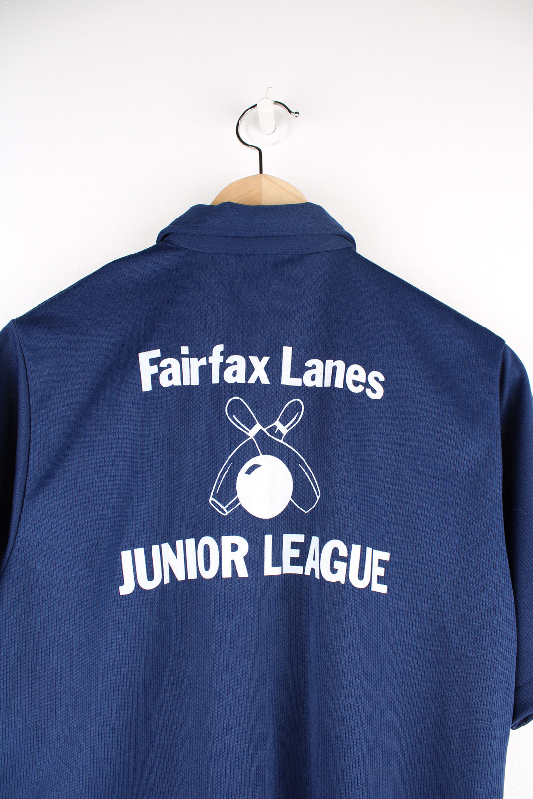 Vintage 1960's/70's made in the USA Hilton Bowling shirt in navy blue. Features 1/4 zip, dagger collar and printed spell-out on the back