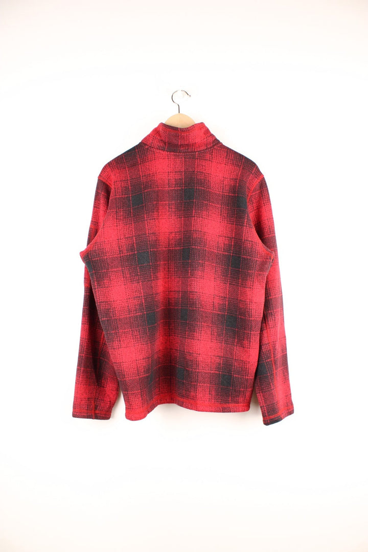 The North Face red and black check fleece with 1/2 zip closure and a white logo patch.