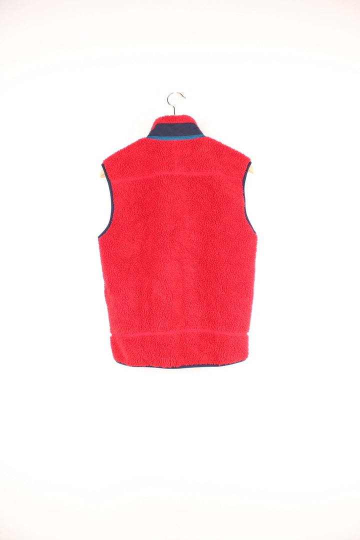 Red Patagonia fleece gilet with blue accents, zip closure, three zipped logos and an embroidered logo patch.