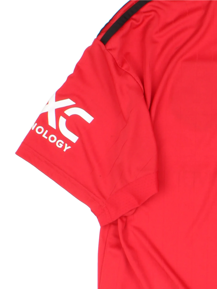 Manchester United 2002/23 Adidas Football Shirt in the red home kit colourway, features printed logos and badge on the front with the classic adidas 3 stripe on the sleeve and button collar.