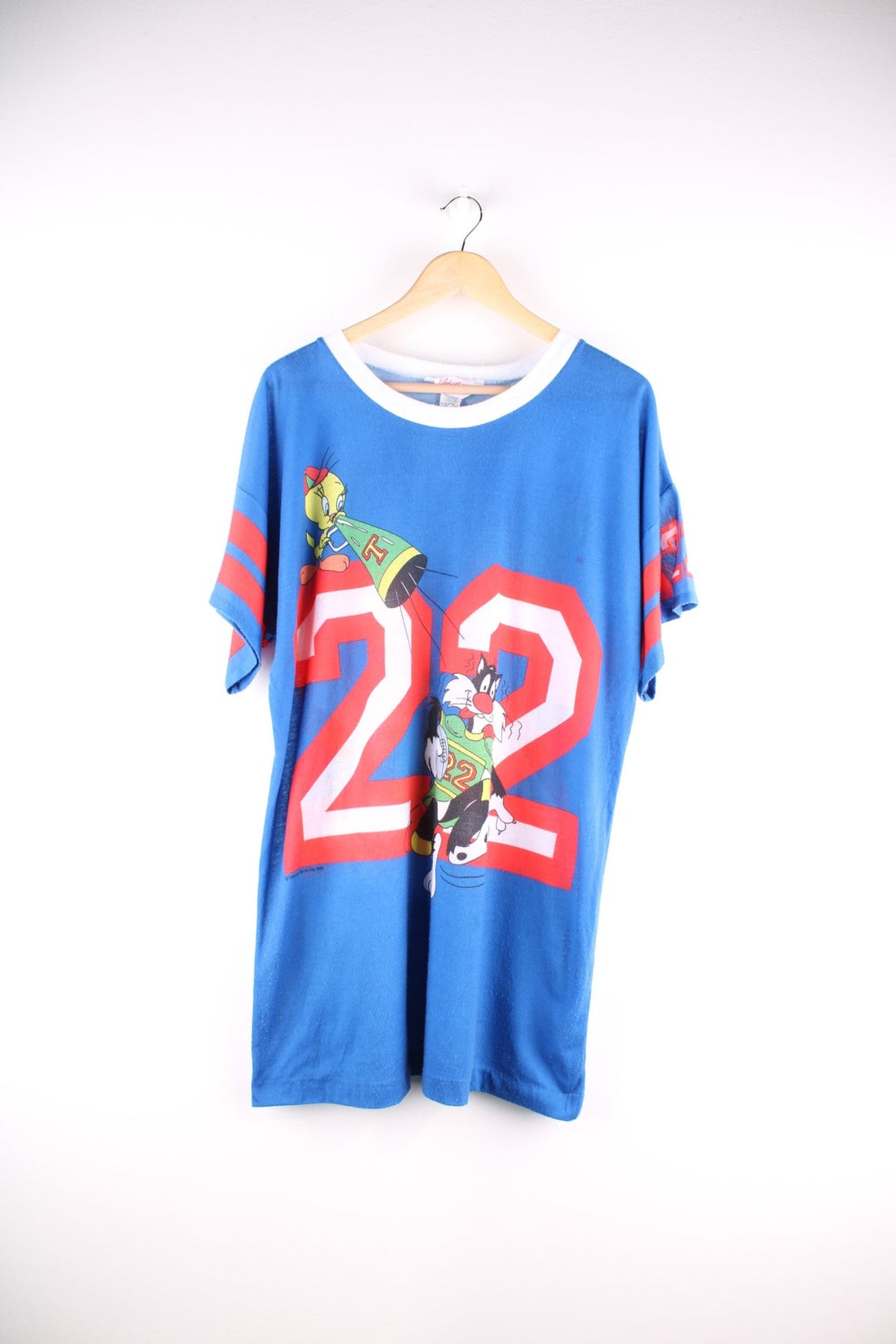 Vintage 1980s Jodie Arden Pyjama shirt in a blue colourway. There is a large graphic printed on the front, with Sylvester and Tweety and the sleeves are sports jersey style with a single stitch hem.