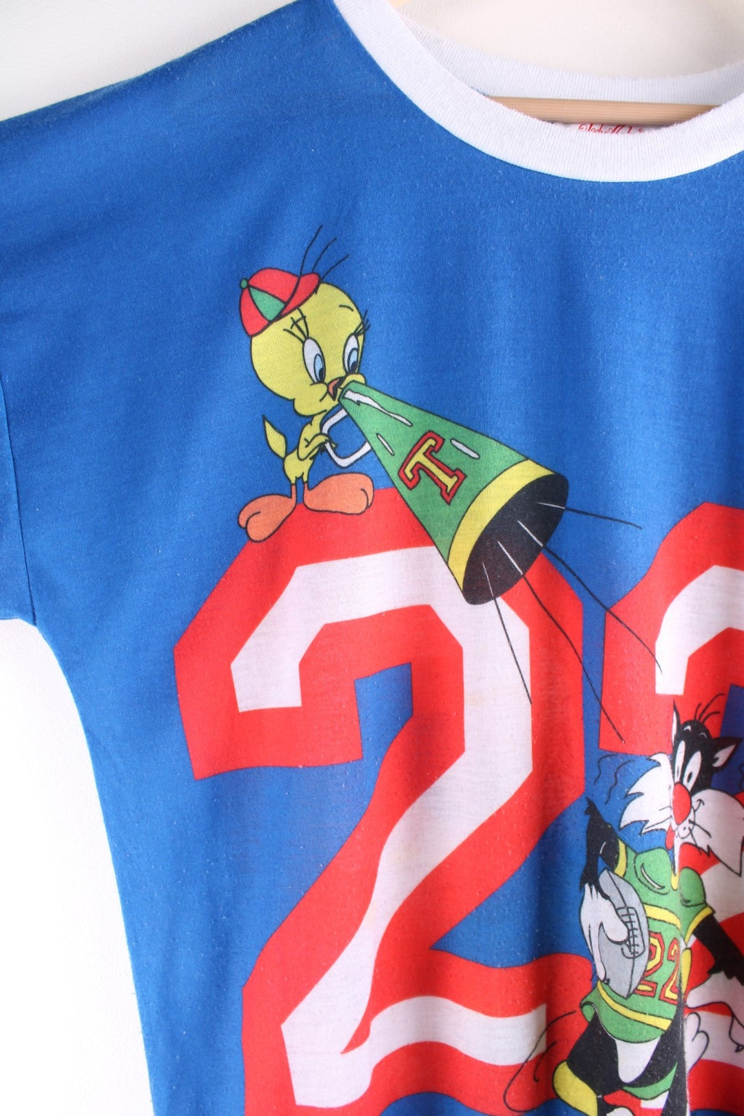 Vintage 1980s Jodie Arden Pyjama shirt in a blue colourway. There is a large graphic printed on the front, with Sylvester and Tweety and the sleeves are sports jersey style with a single stitch hem.