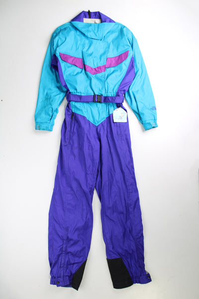 Vintage 90's blue The North Face ski suit. Padded jumpsuit with belt. Closes with a zip/ velcro and has an elasticated waistband at the back. fair condition - Lots of marks throughout, has a old ski pass attached (see photos) Size in Label: Womens 10