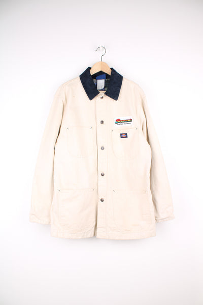 Dickies Chore Workwear Jacket in a off white colourway with a dark blue corduroy collar, blanket lining, button up with multiple pockets, and has the logo embroidered on the front alongside 'Siperstein's' company logo.