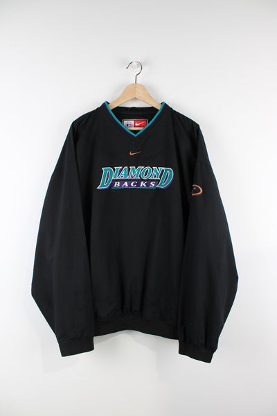 Vintage Nike Diamond Backs MLB training top in black, v neck with two side pockets, has centre swoosh and Diamond Backs spell-out on the front. 