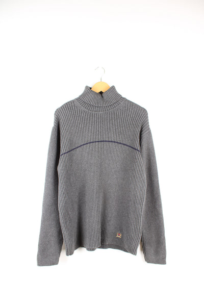 Tommy Hilfiger grey rib knit roll neck jumper. Features a horizontal darker grey stripe across the chest and embroidered logo on the hem. Made from a 100% cotton. good condition  Size in Label:  XL - Measures like a Mens M