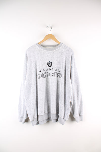 Vintage NFL Oakland Raiders sweatshirt in grey, has embroidered spell out and logo across the front.