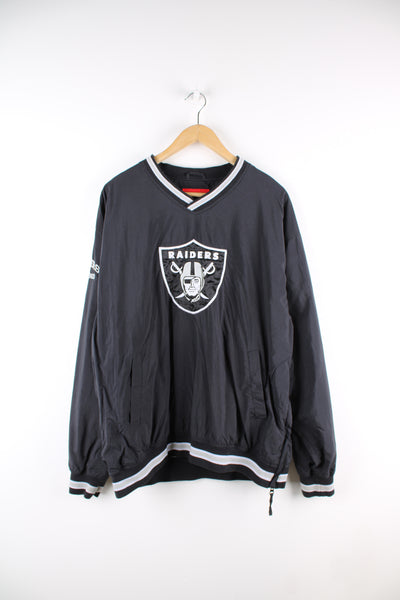 Vintage NFL Oakland Raiders drill top in black and grey team colourway, v neck, side pockets, and has logo embroidered on the front. 