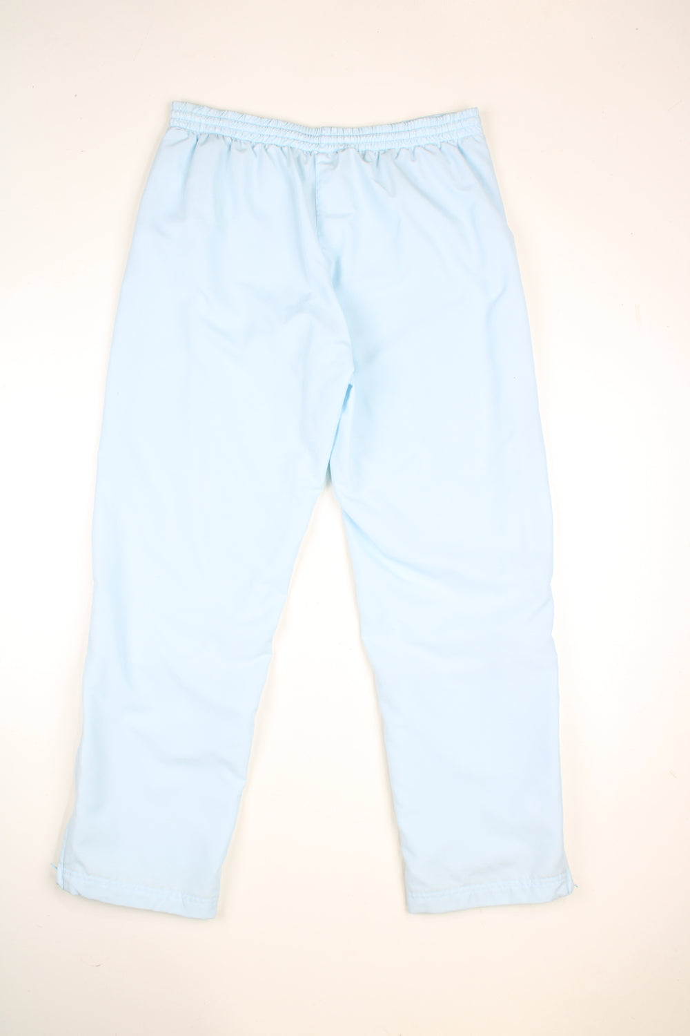 Vintage Adidas tracksuit bottoms in a baby blue colourway, elasticated waist, pockets and has logo embroidered on the front.