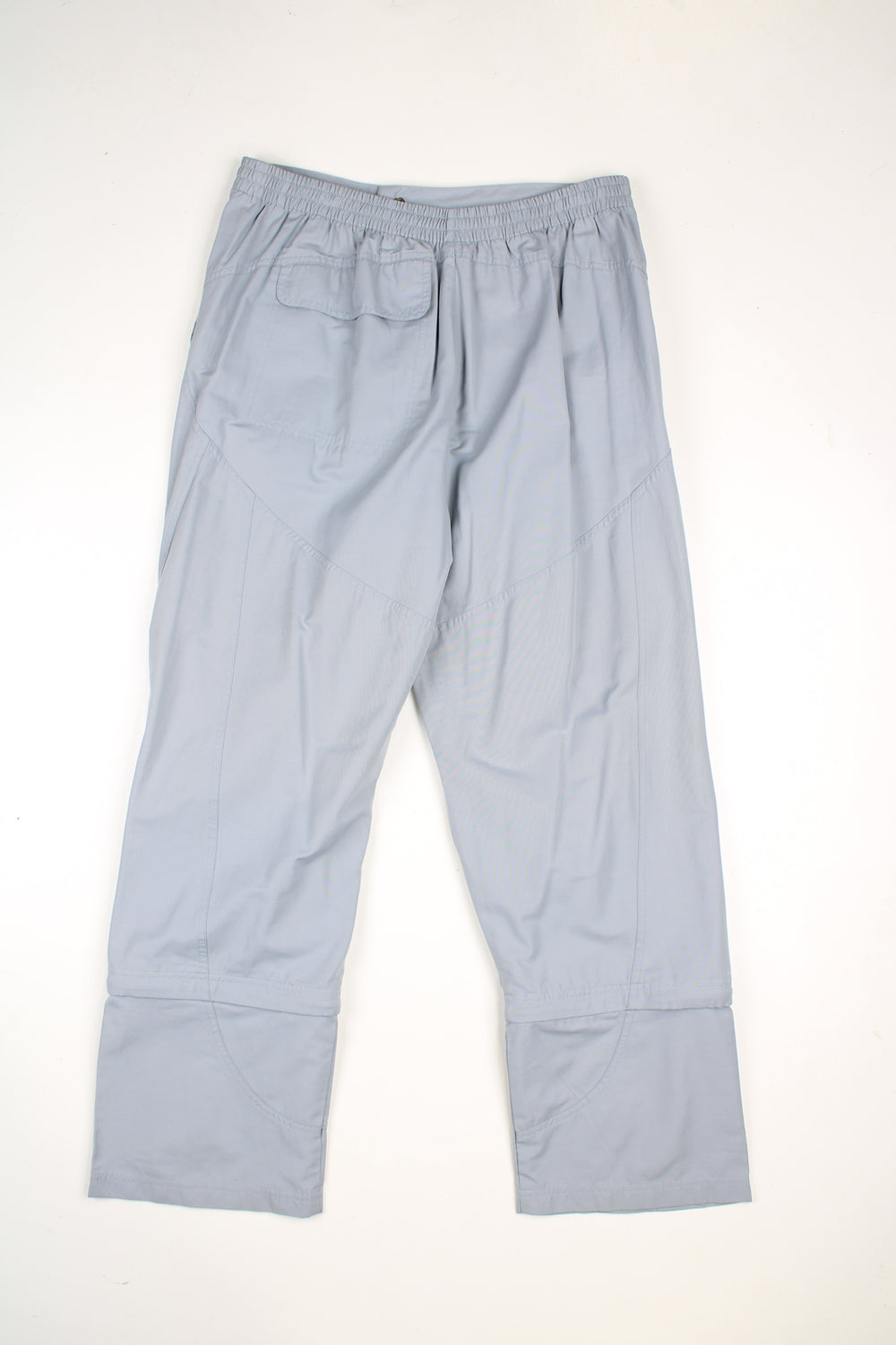 Vintage Adidas tracksuit bottoms in a grey colourway, elasticated waist, multiple pockets,  has logo embroidered on the front and detachable zip on the legs to make them quarter length.