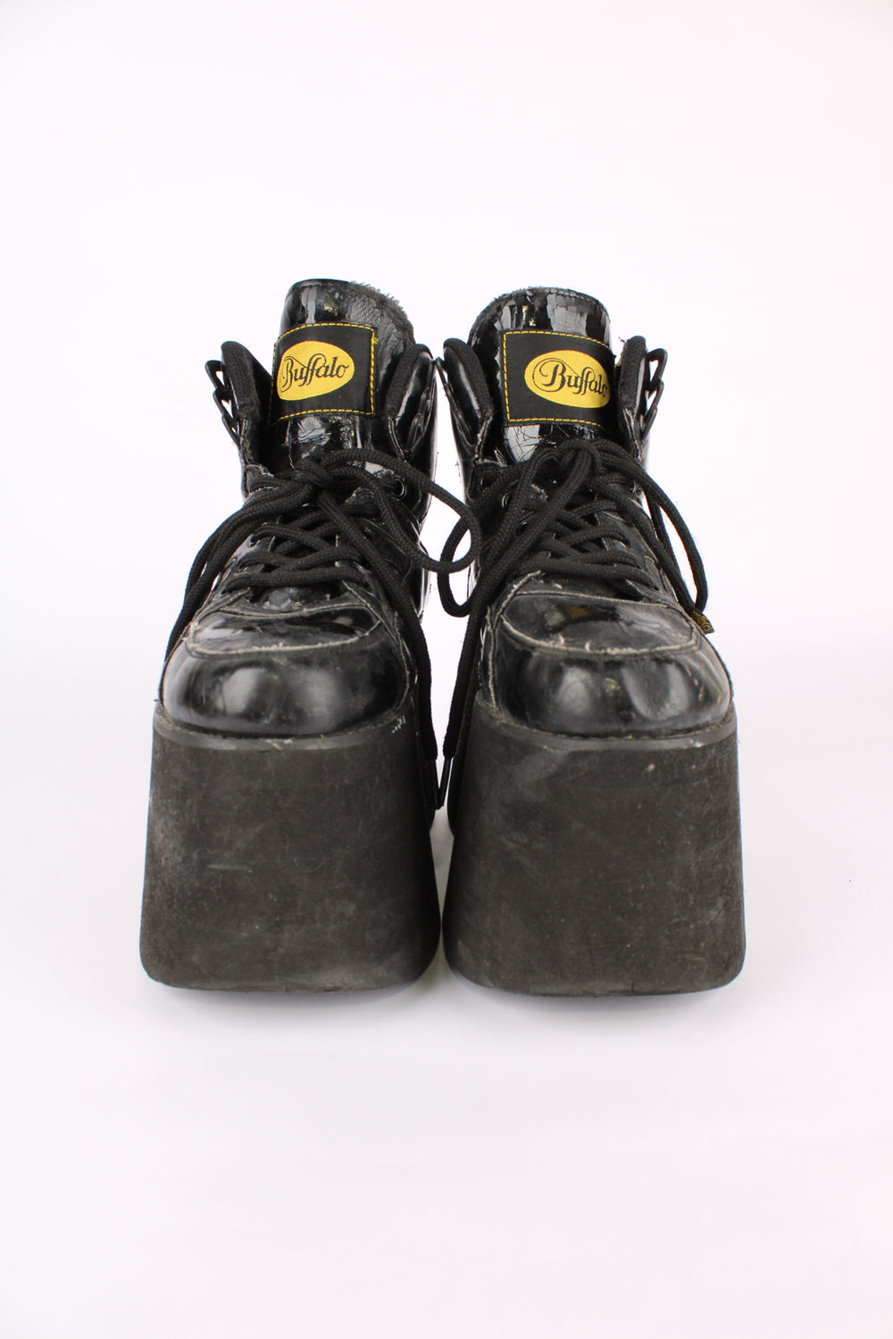 Buffalo Tower black patent leather platform lace up trainers, featuring buffalo branding on the back of the heel