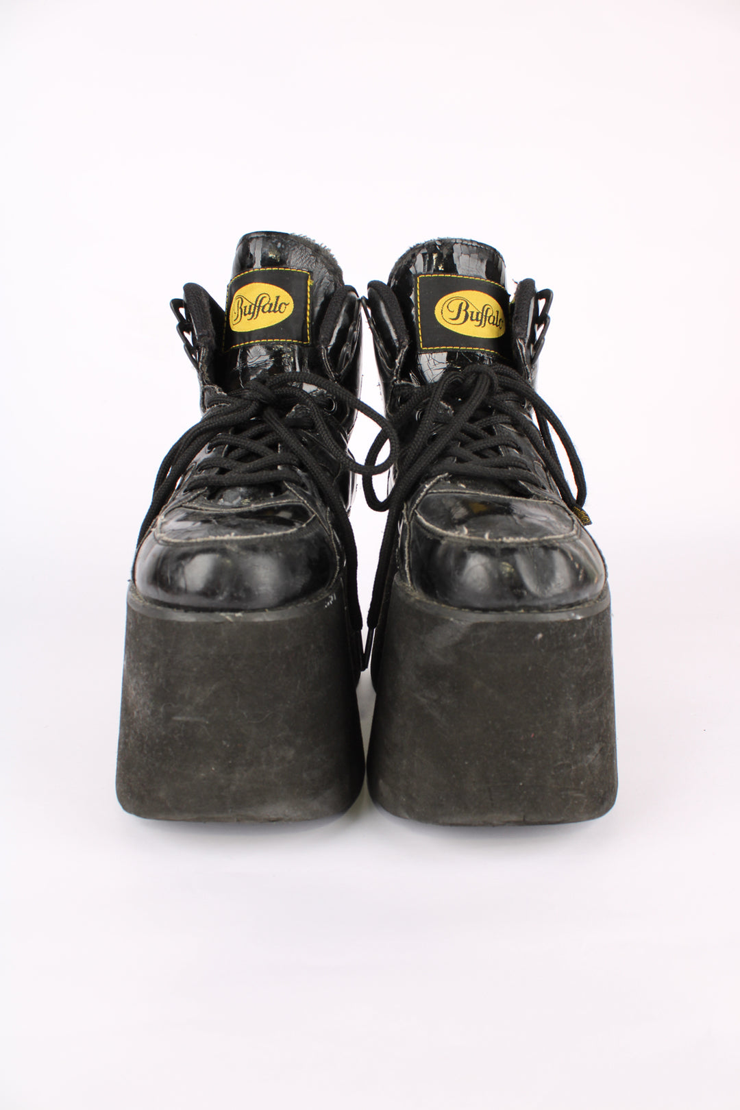 Buffalo Tower black patent leather platform lace up trainers, featuring buffalo branding on the back of the heel