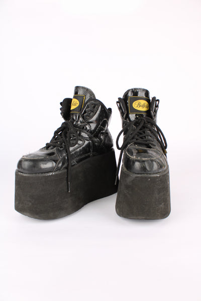 Buffalo Tower black patent leather platform lace up trainers, featuring buffalo branding on the back of the heel