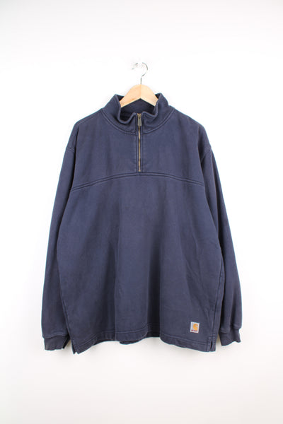 Carhartt Sweatshirt in a blue colourway, quarter zip up, plain with the logo embroidered at the bottom.