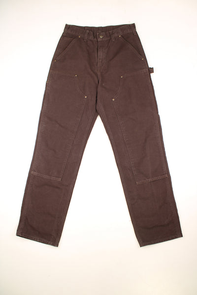 Carhartt Double Knee Jeans in a brown colourway, multiple pockets, and has the logo embroidered on the back pocket.