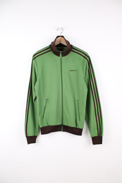 Adidas Tracksuit Jacket in a green and brown colourway, zip up, side pockets, and has the logo embroidered on the front.