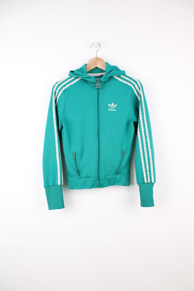 Adidas Tracksuit Jacket in a turquoise blue colourway, zip up, hooded, side pockets, and has the logo embroidered on the front.