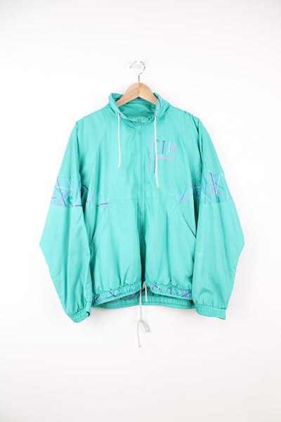 Lotto Shell Jacket in a turquoise blue colourway, zip up, big adjustable collar, side pockets, and has the logo embroidered on the front.