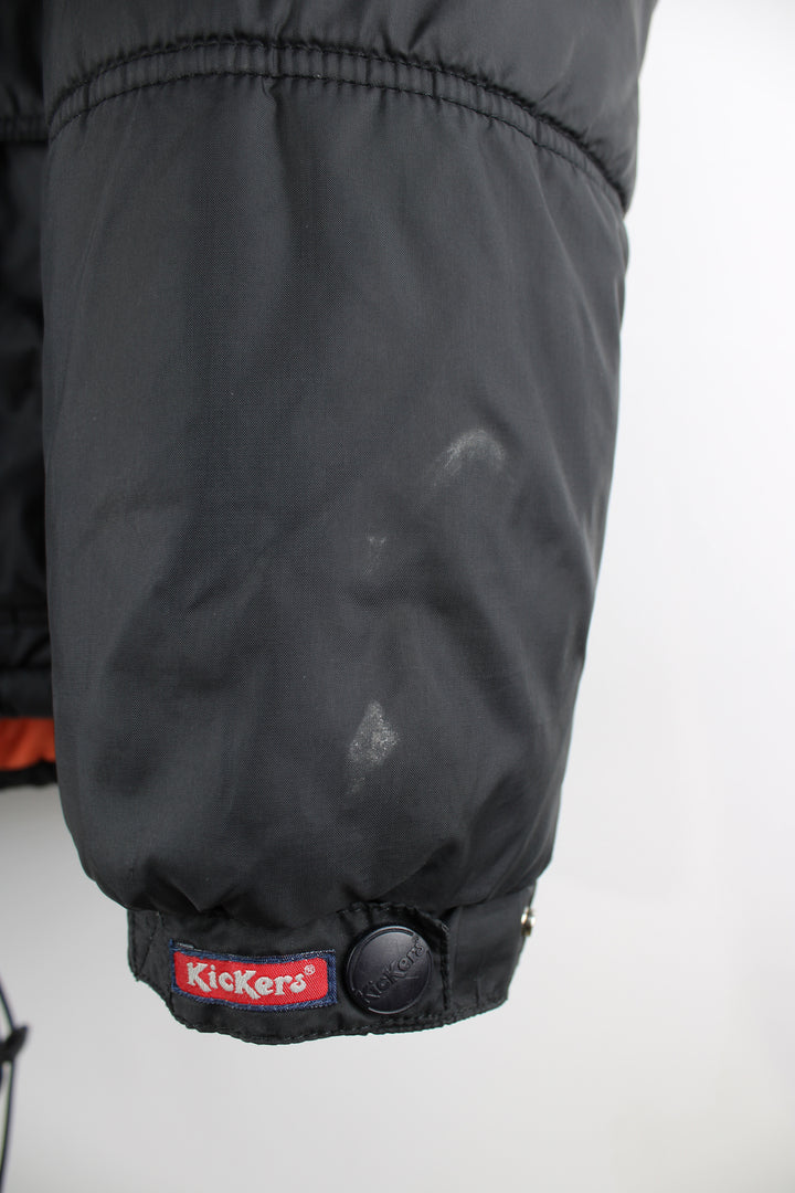 Vintage Kickers puffer jacket in black, zip up, insulated, multiple pockets, hooded and has the logo embroidered on the front.