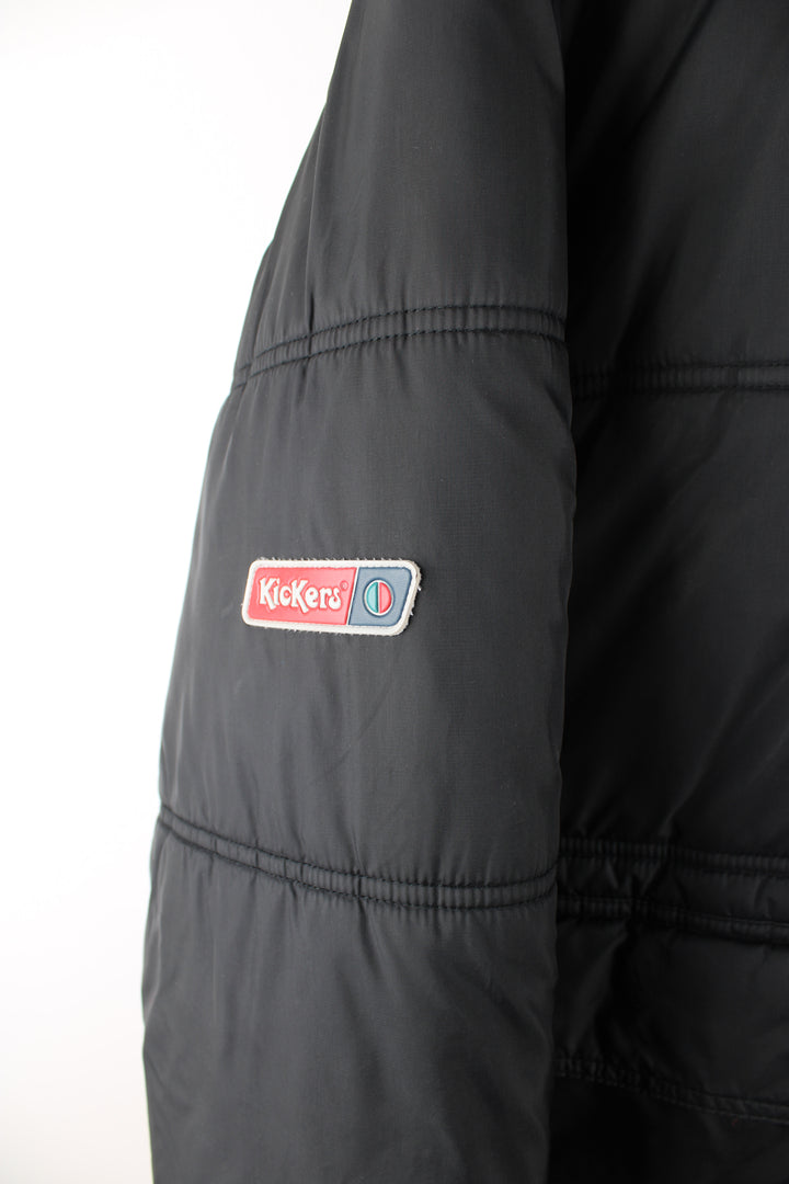 Vintage Kickers puffer jacket in black, zip up, insulated, multiple pockets, hooded and has the logo embroidered on the front.