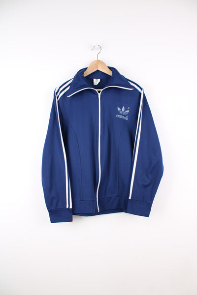 Vintage Adidas Tracksuit Top in a blue and white colourway, zip up, big collar, and has the logo printed on the front.