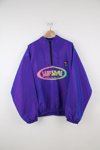 Vintage Surf Style Windbreaker in a purple colourway, half zip, side pockets, and has the logo printed on the front.