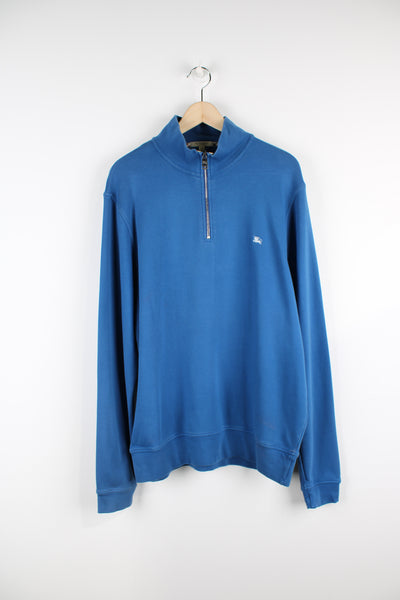 Burberry bright blue 1/4 zip sweatshirt features signature embroidered logo on the chest and high neck