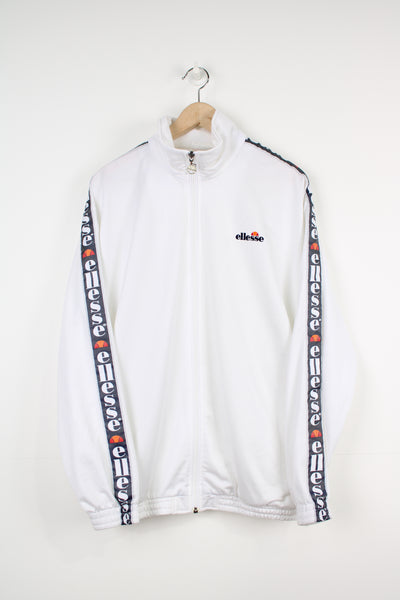 Ellesse white satin zip through track jacket with embroidered logo on the chest and ribbon down the sleeves