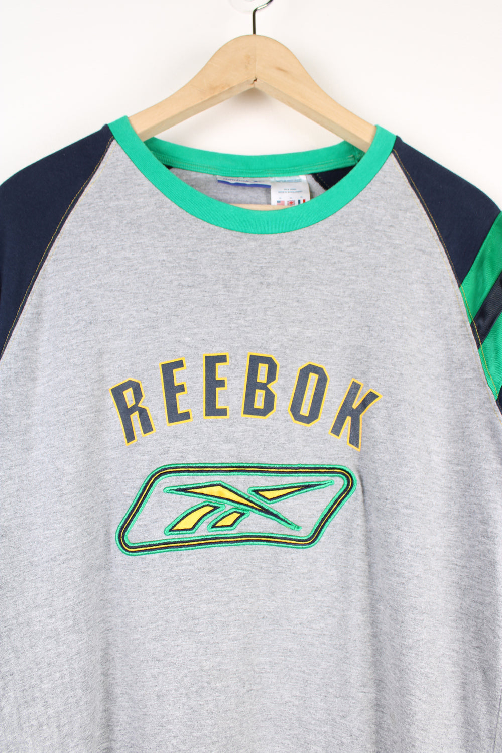 Vintage Reebok T-shirt, grey, blue and green colourway, crewneck, short sleeved and has embroidered logos on the front and sleeve