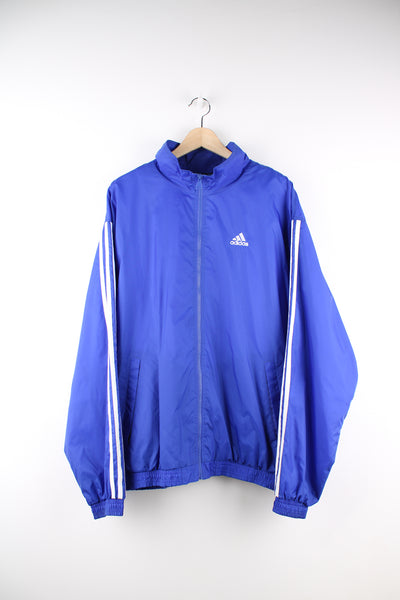 Adidas Tracksuit Jacket in a blue colourway, zip up, side pockets, and has the logo embroidered on the front.
